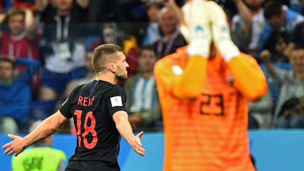 Croatia's forward Ante Rebic (L) celebrates after scoring their opener as Argentina's goalkeeper Willy Caballero reacts in foreground in Nizhny Novgorod on June 21, 2018