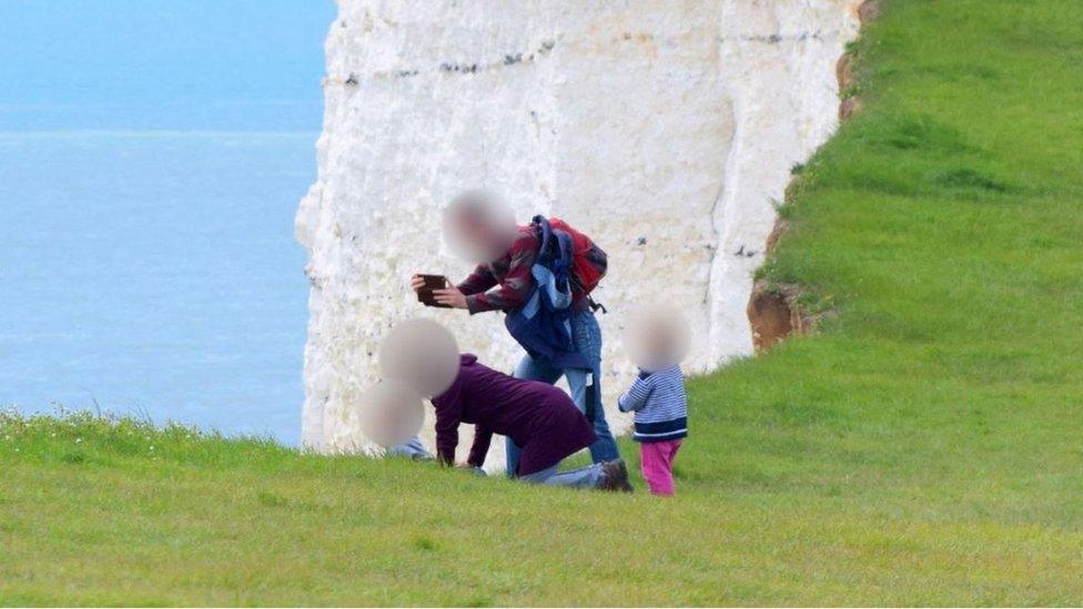 Family on cliff edge