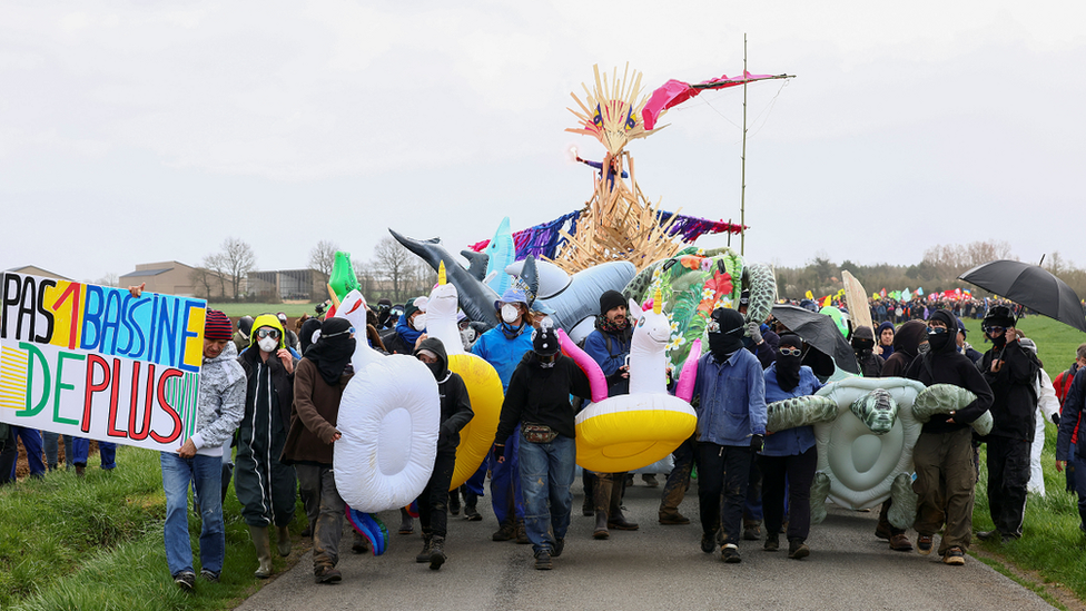 The large procession is calling for an end to the development