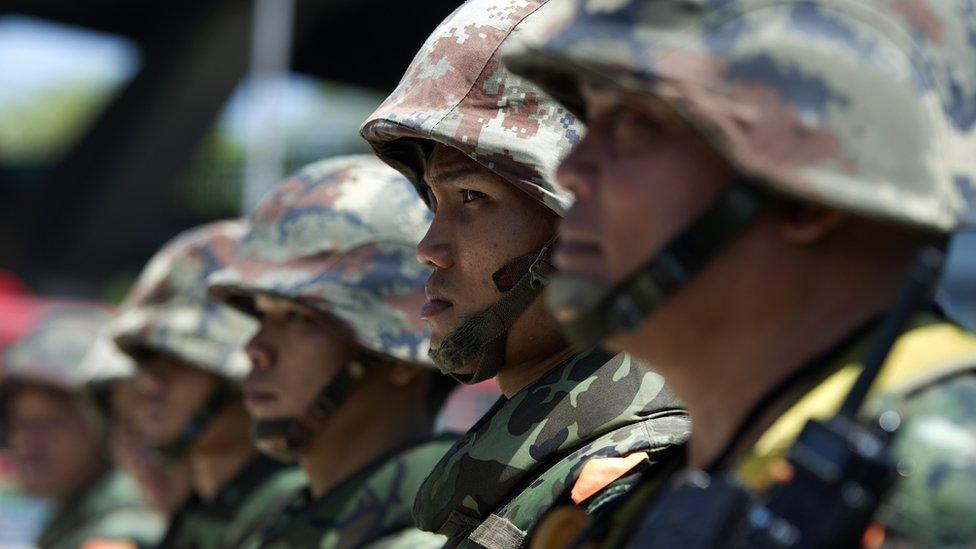 Thai soldiers stand guard as anti-government protest leaders meet with army chief General Prayut Chan-O-Cha at the Army Club in Bangkok on May 22, 2014.