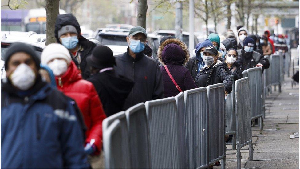 People wait at a food bank in NY