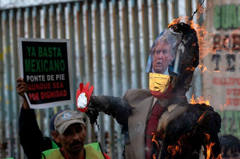 A Trump effigy is burned on the southern side of the US-Mexico border