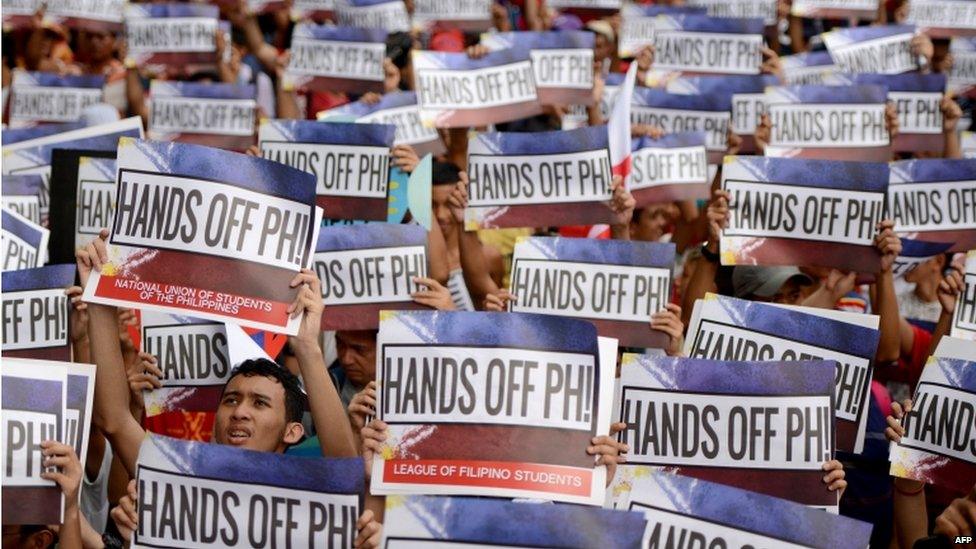 Activists hold a protest in front of the Chinese Consular Office in Manila on 12 June 2015, as the country commemorates the 117th anniversary of the Philippines' declaration of independence from Spain.