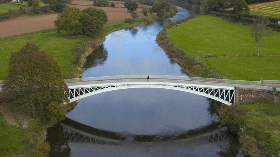 An aerial view of a pedestrian bridge over the River Wye in Llandogo