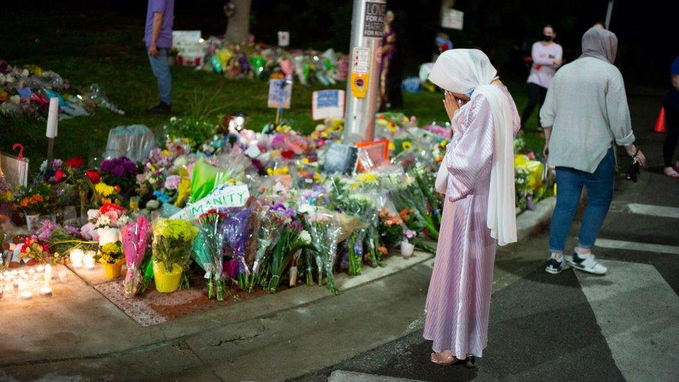 Members of the Muslim community and supporters light candles and place flowers at a memorial on June 8, 2021 in London, Canada