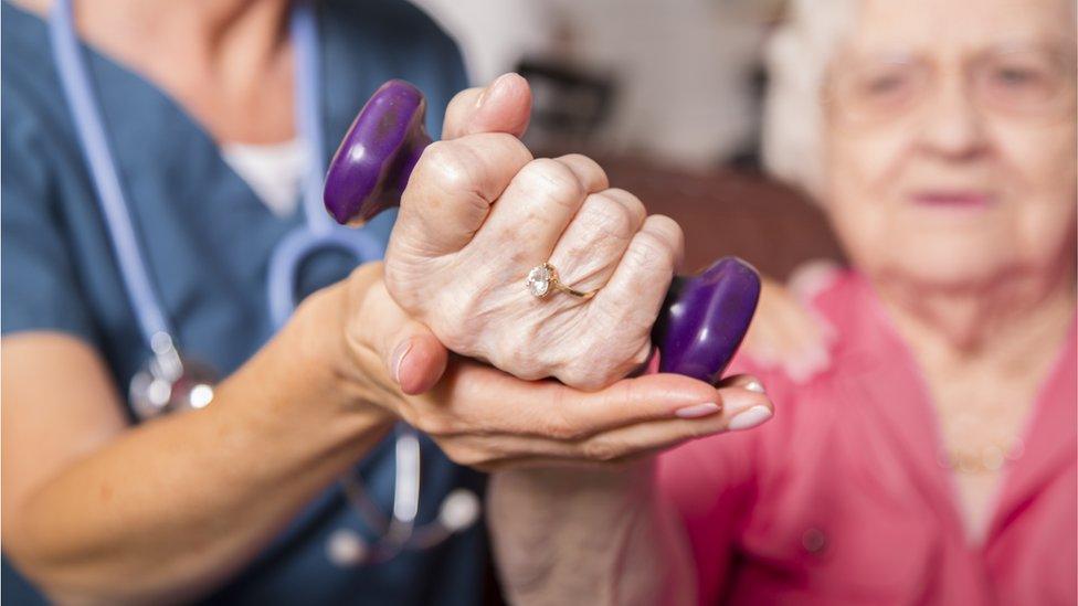 Elderly woman receiving physiotherapy