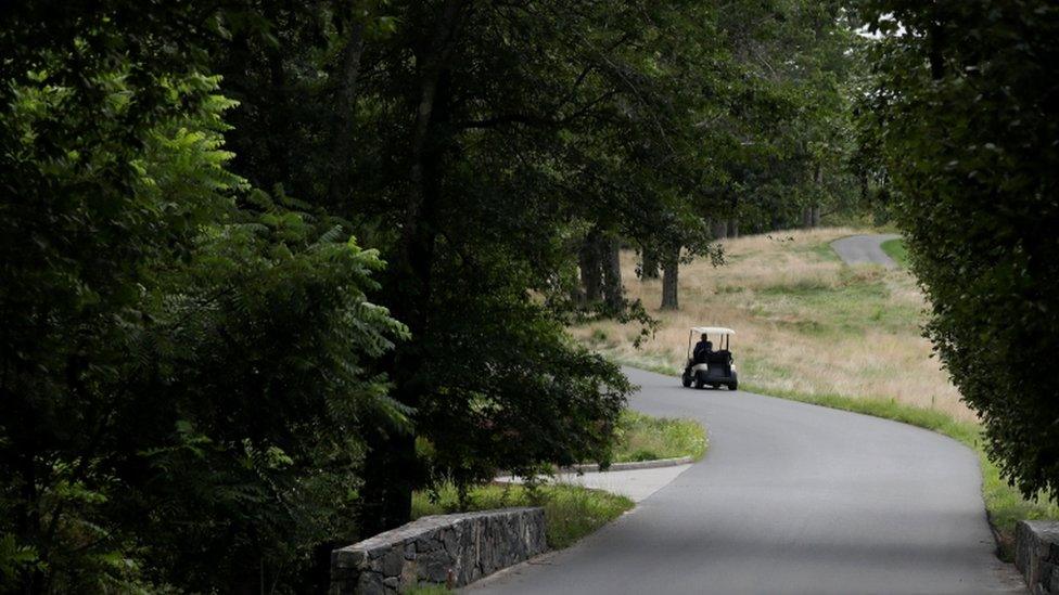 A Secret Service agent patrols the golf course