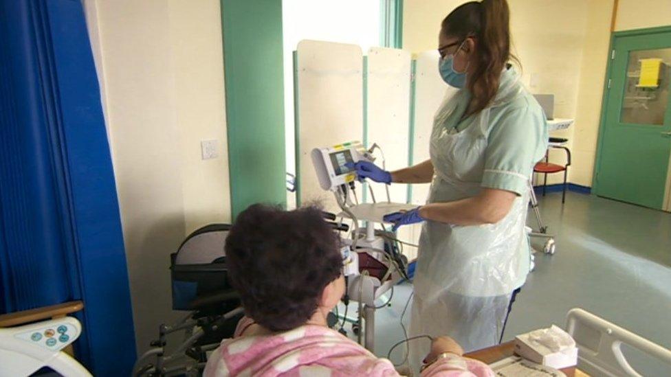 A member of medical staff treating a patient in hospital