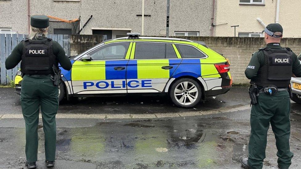 Police officers at scene of the pipe bomb attack on a woman's home in Londonderry