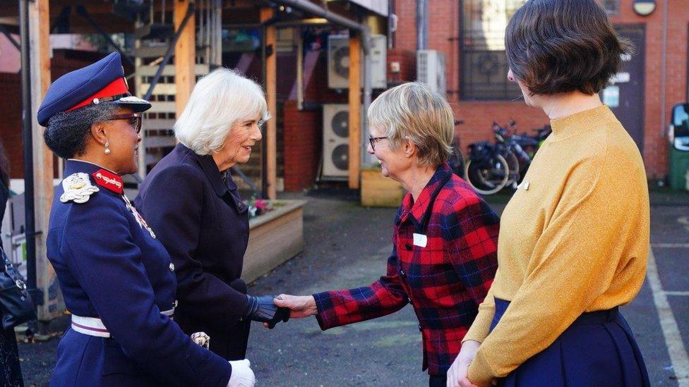 Photo of the Queen greeting staff at Emmaus Bristol