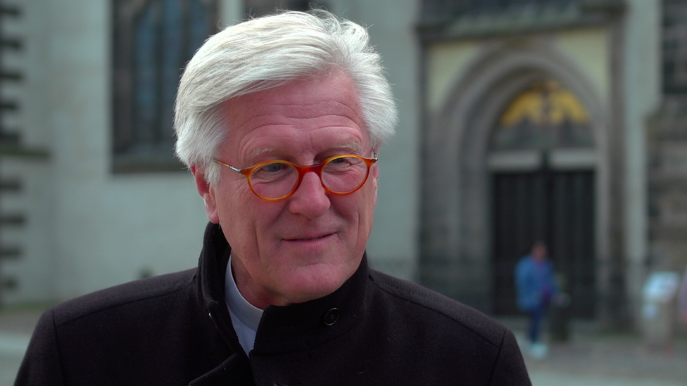 Bishop standing outside Wittenberg church door