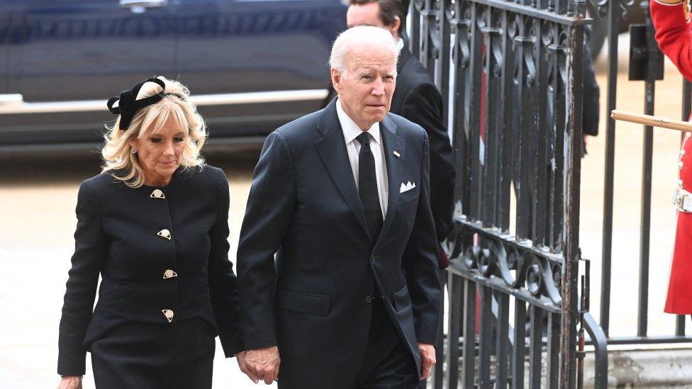 Joe Biden and his wife, Jill Biden, in black walking into Westminster Abbey