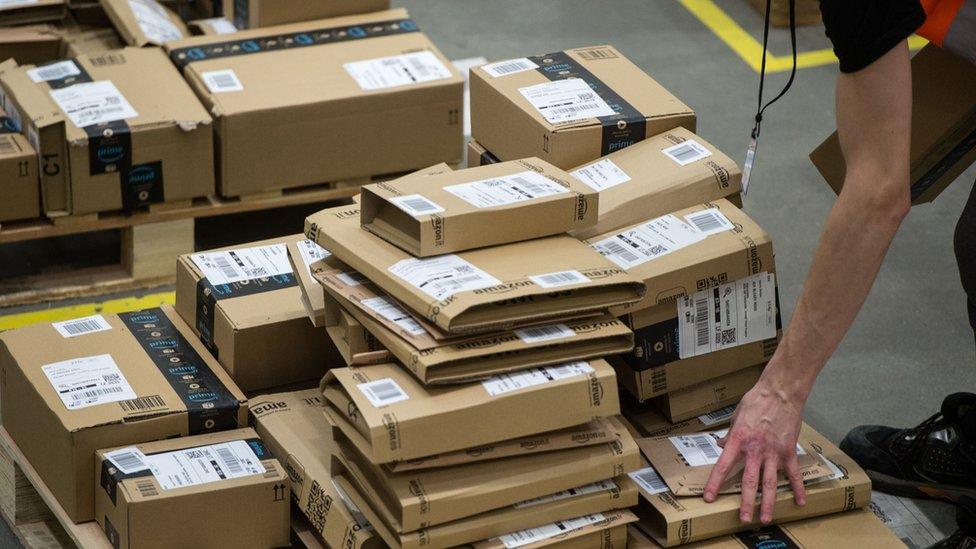 Amazon packages in a large pile at a Warehouse