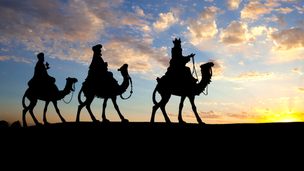 Stock image showing the biblical scene of three wise men on camels