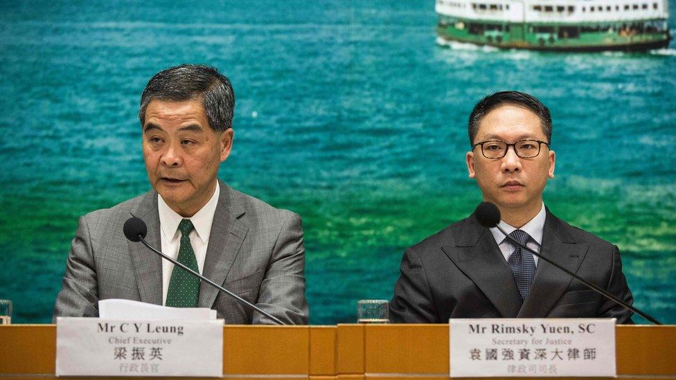 Hong Kong Chief Executive Leung Chun-ying (L) and Secretary for Justice Rimsky Yuen (R) take part in a press conference in Hong Kong on November 7, 2016