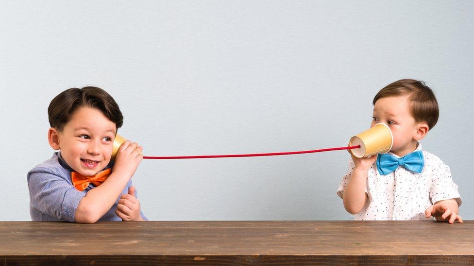 Kids-talking-through-paper-cups-and-string.