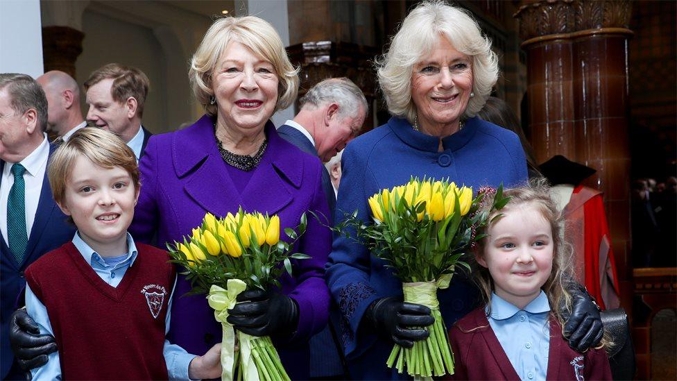 Sabina Coyne and the Duchess of Cornwall as they receive flowers as they attend a reception at Victoria Gallery and Museum, University of Liverpool