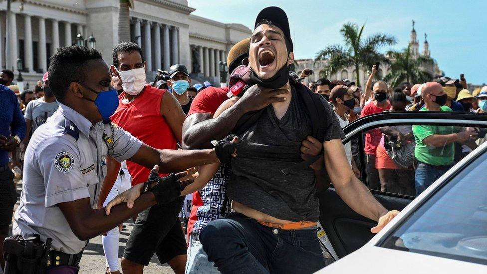 A man is arrested during a demonstration against the government of Cuban President Miguel Diaz-Canel in Havana, 11 July 2021