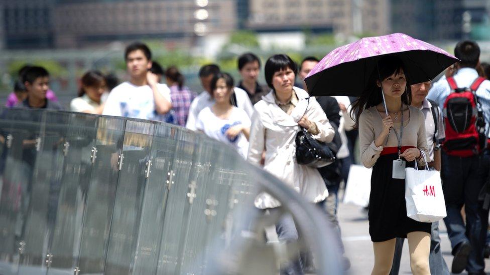 White-collars workers walk to their lunch break in Pudong Luziajui business district in Shanghai, China,