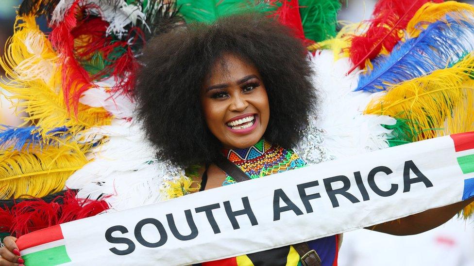 A South African supporter waves a "South Africa" banner as she attends the Fifa international friendly football match between South Africa and Jamaica at the Moses Mabhida Stadium in Durban , South Africa on 7 April 2019