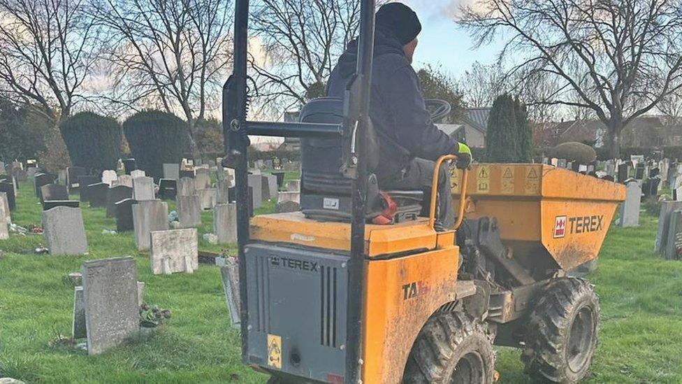 Digger next to graves