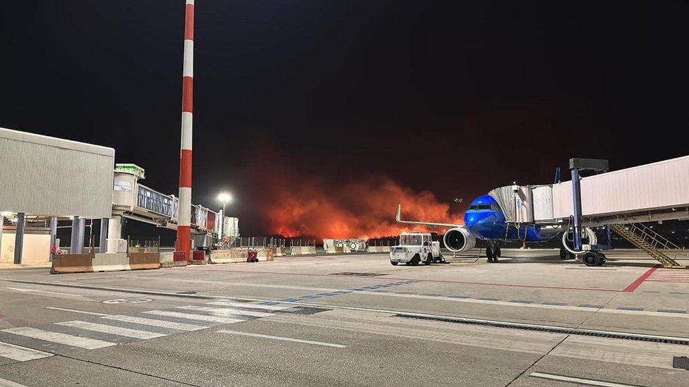 Flames rise as a strong fire burns near the Falcone Borsellino Airport in Palermo