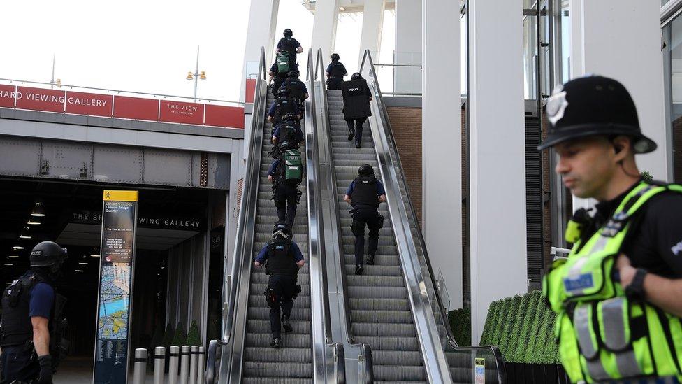 Armed police climb escalator in The Shard