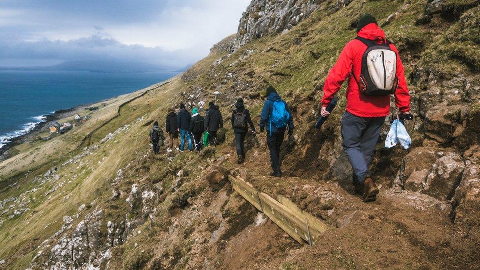 Green Group members walk past a strengthened pass