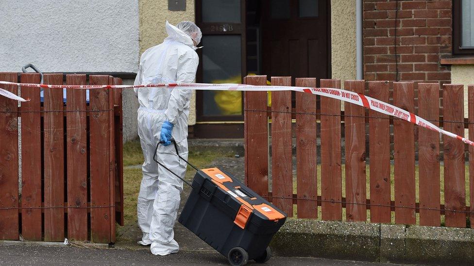 Forensic officers are at the flat in Derrycoole Way