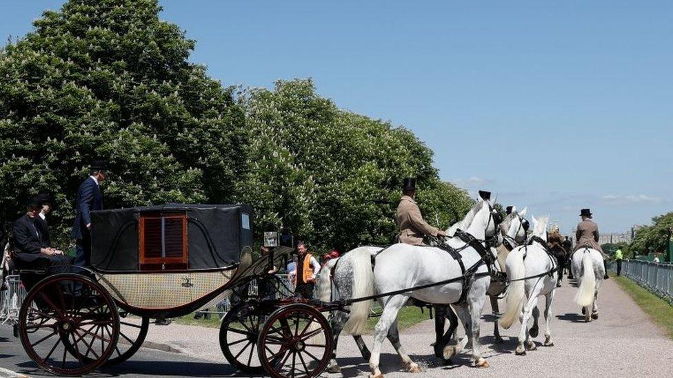 A carriage is pulled by four Windsor Grey horses from Windsor Castle during a dress rehearsal of the wedding of Prince Harry and Meghan Markle outside Windsor Castle on 17 May.