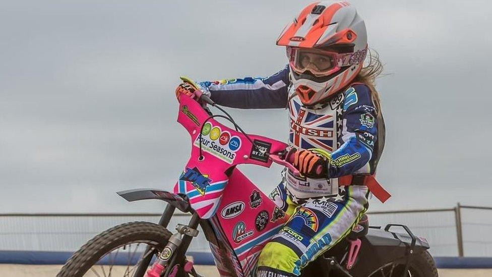 Chloe riding her bike on the speedway track
