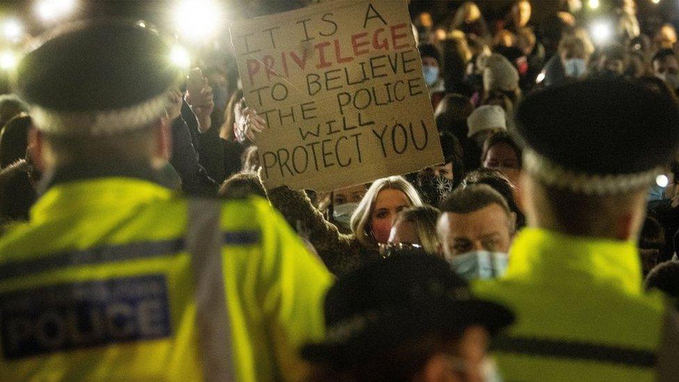 Woman holds up placard at vigil to Sarah Everard at Clapham Common