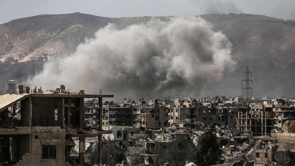 Smoke billows following a reported air strike in a rebel-held part of the Jobar district, on the eastern outskirts of the Syrian capital Damascus, on 19 March 2017