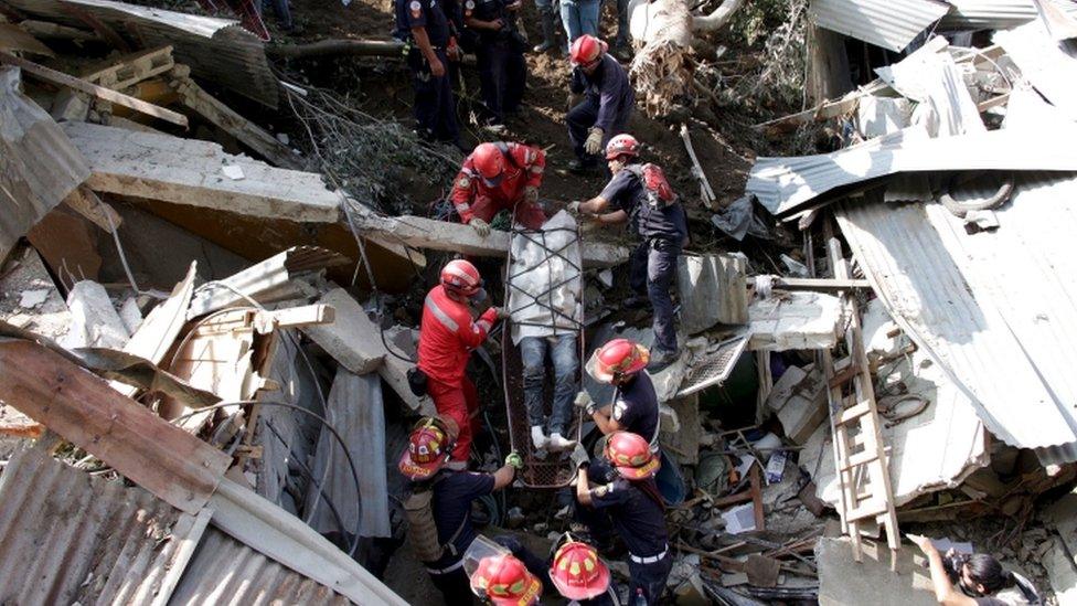 Rescue team members retrieve the body of a landslide victim in Santa Catarina Pinula, on the outskirts of Guatemala City, October 2, 2015.