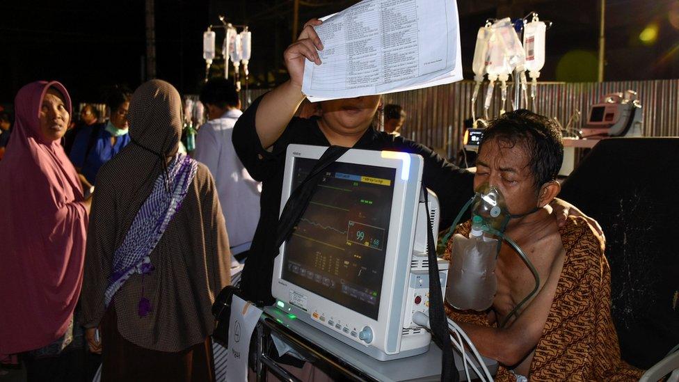 Patients in a parking lot outside Mataram city hospital - 5 August