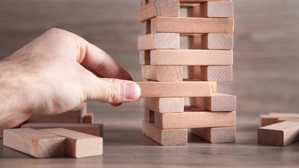 A man plays Jenga