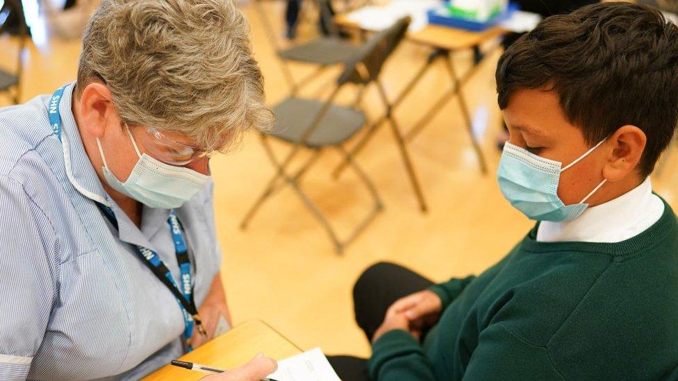 Nurse giving child a vaccine