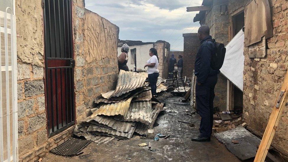 Piles of corrugated iron build up in the aftermath of the fire