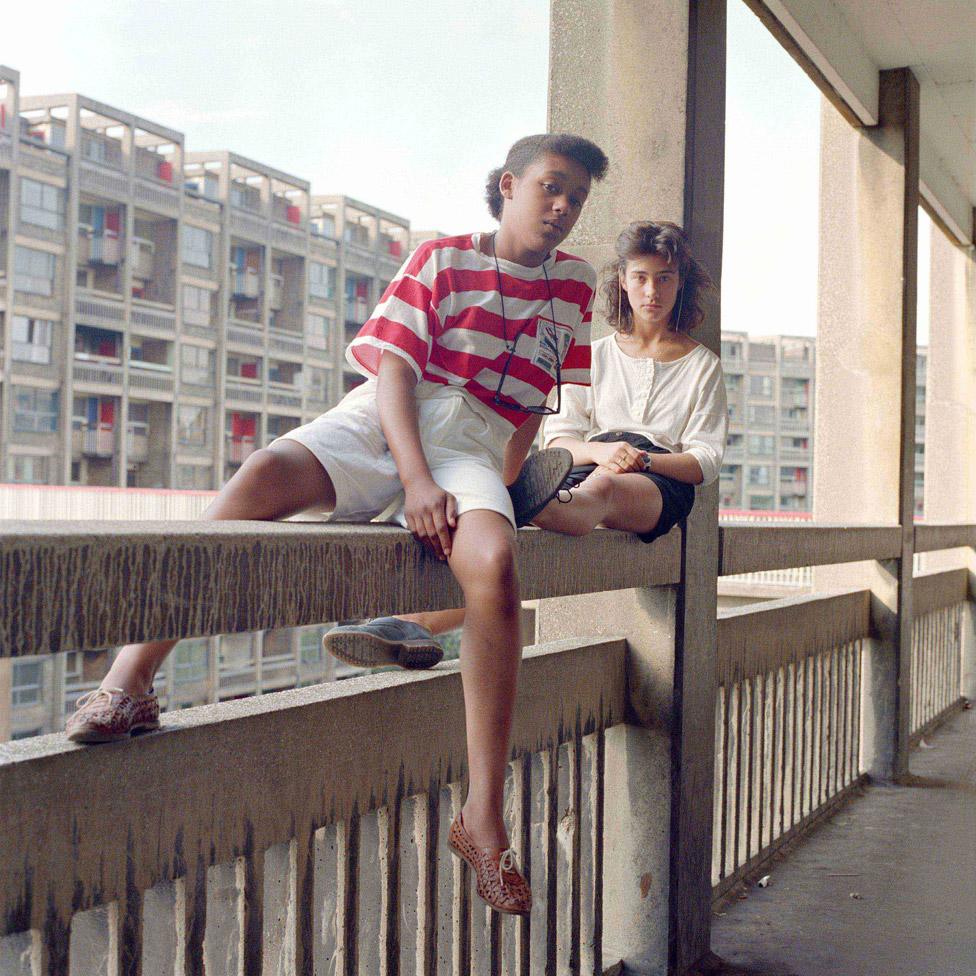 Bill Stephenson: Donna and Carmen sit on an unguarded fourth storey concrete parapet. Hyde Park Flats, Sheffield, 1988