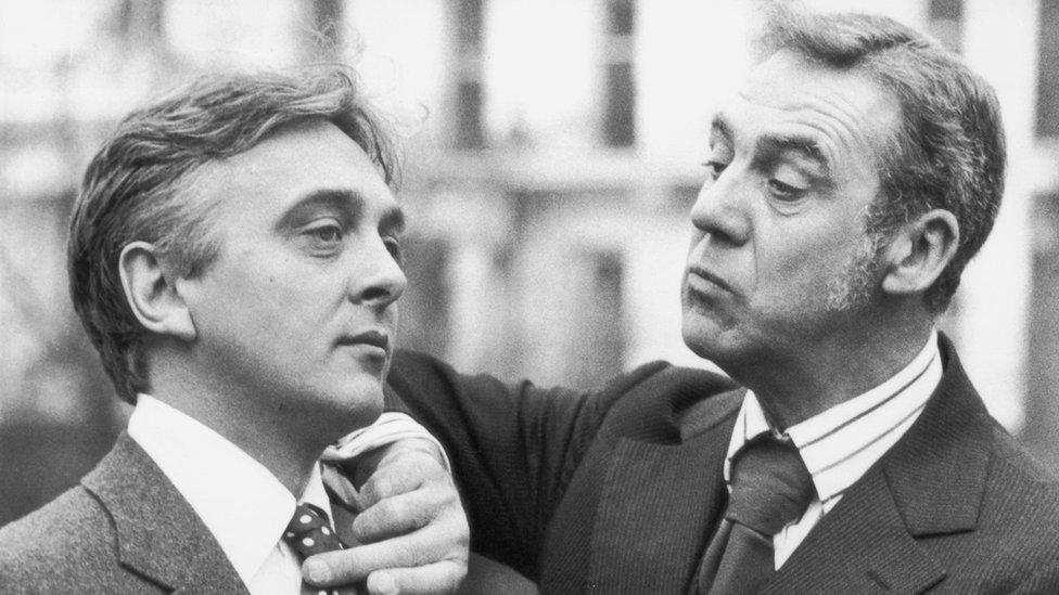 English actor David Hemmings (1941 - 2003) has his tie adjusted by actor Michael Aldridge, 12th February 1975 for an adaptation of Jeeves and Wooster