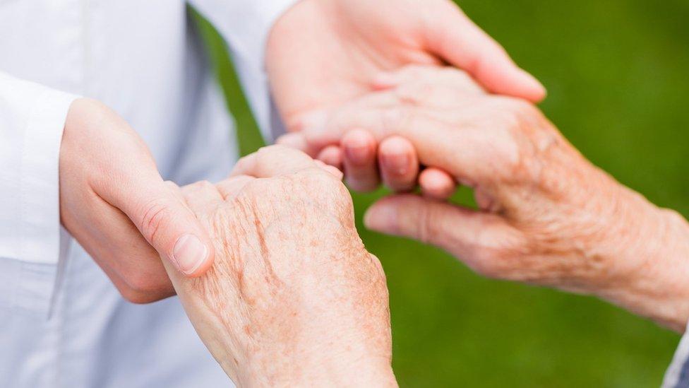 A woman holding another woman's hands