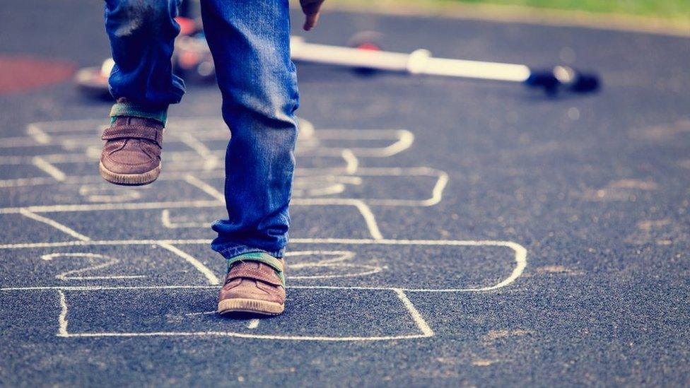 Child playing hopscotch