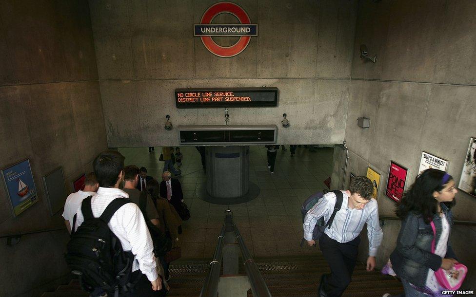 Commuters at a disrupted tube station