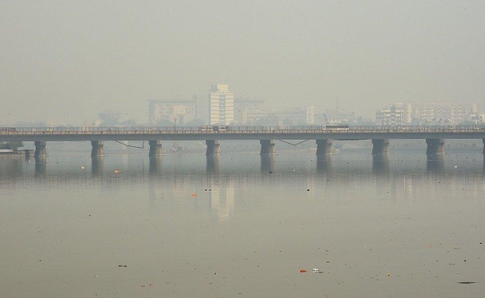 Traffic is pictured on a bridge over the Sabarmati River during heavy smog conditions in Ahmedabad on February 5, 2019.