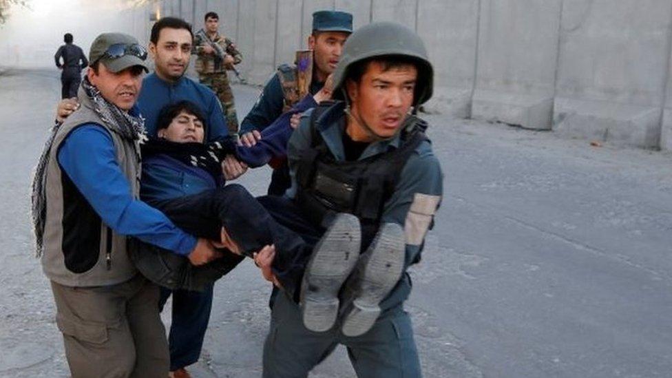 Afghan policemen carry an injured man after the blast in Kabul, Afghanistan 31 October, 2017