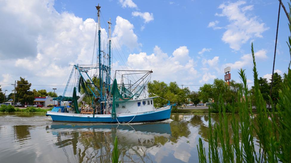 A shrimp boat heading out to fish on Bayou Lafourche