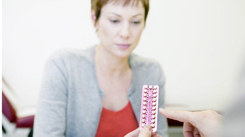 A woman is shown the contraceptive pill