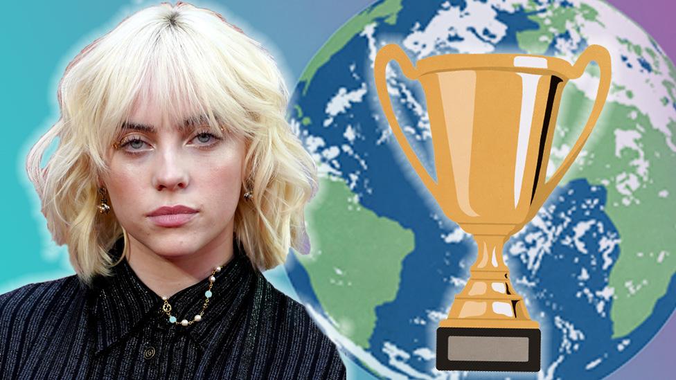 Billie Eilish with a world and a trophy