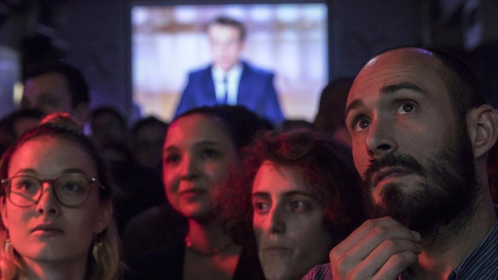 Supporters of French presidential election candidate Emmanuel Macron for the "En Marche!" movement (Onwards!) watch a live brodcast of the face-to-face televised debate between Emmanuel Macron and far-right Front National (FN) party candidate, Marine Le Pen in a bar in Paris, France, 03 May 2017.