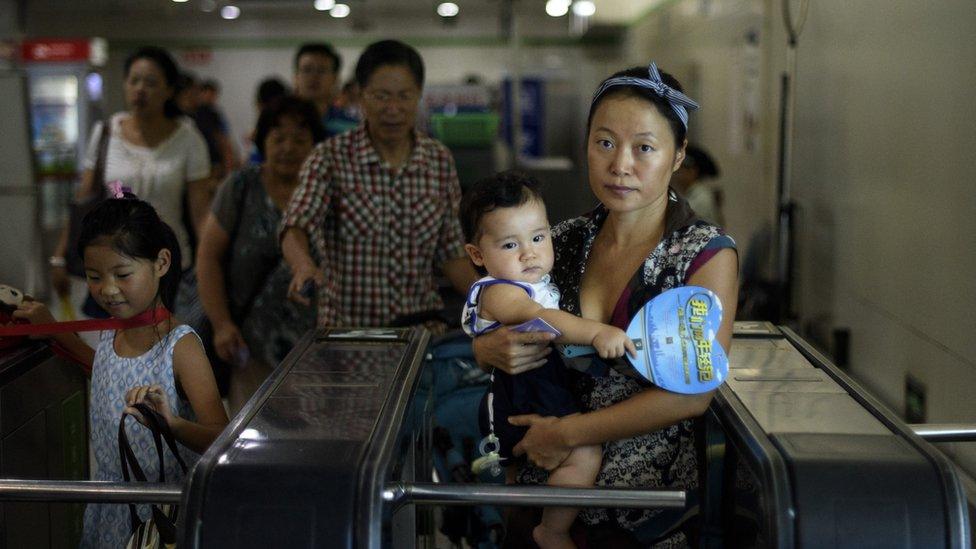 A mother arrives at a subway station to an event of the world breastfeeding week